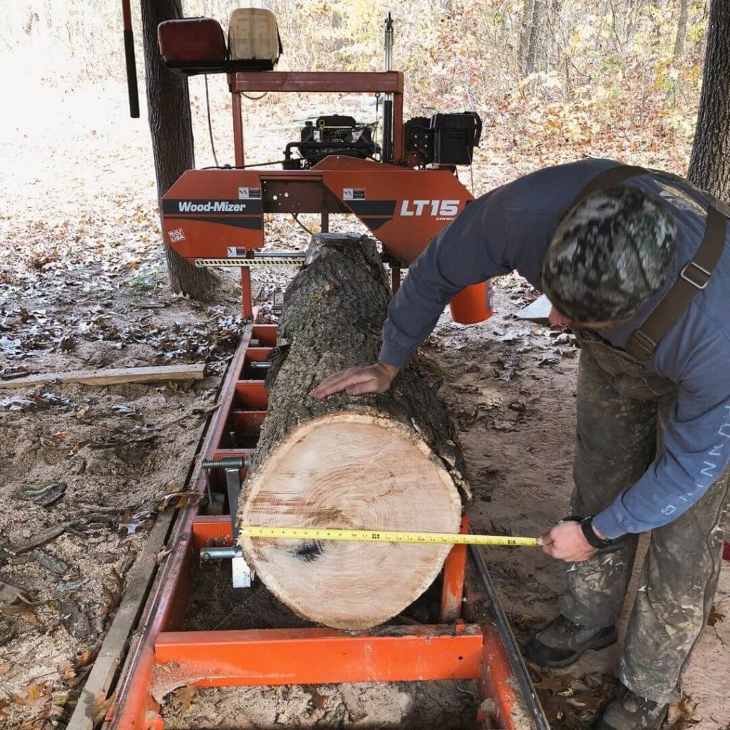 Measuring log to cut and plane for a live edge bar for Chicago