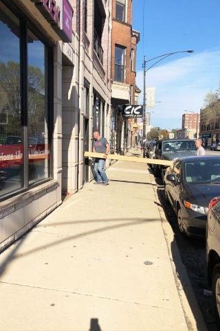 Men bring beams into the new Lakeview Taproom during renovation