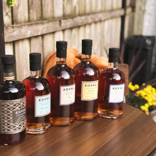 KOVAL Single Barrel Bourbon Whiskeys on patio table