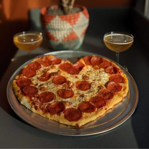 Heart shaped pizza and beer in champagne glasses for Valentines Day at the Lakeview Taproom